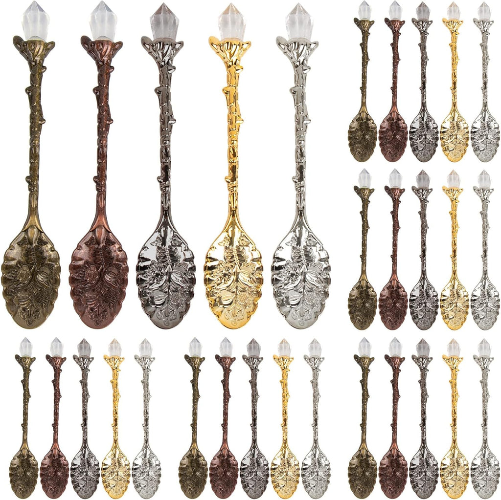 Set of decorative spoons in various metallic finishes on a white background