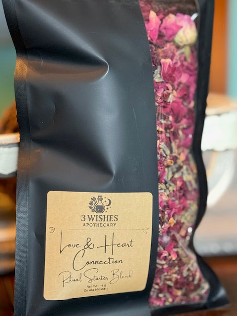 Black tea bag with '3 Wishes Apothecary' label and visible herbal blend