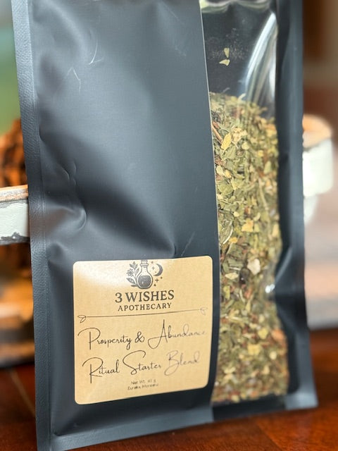 Tea bag with '3 Wishes Apothecary' label and visible ritual blend.